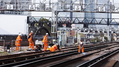 Workers verifying track safety on the ground level at London Bridge.